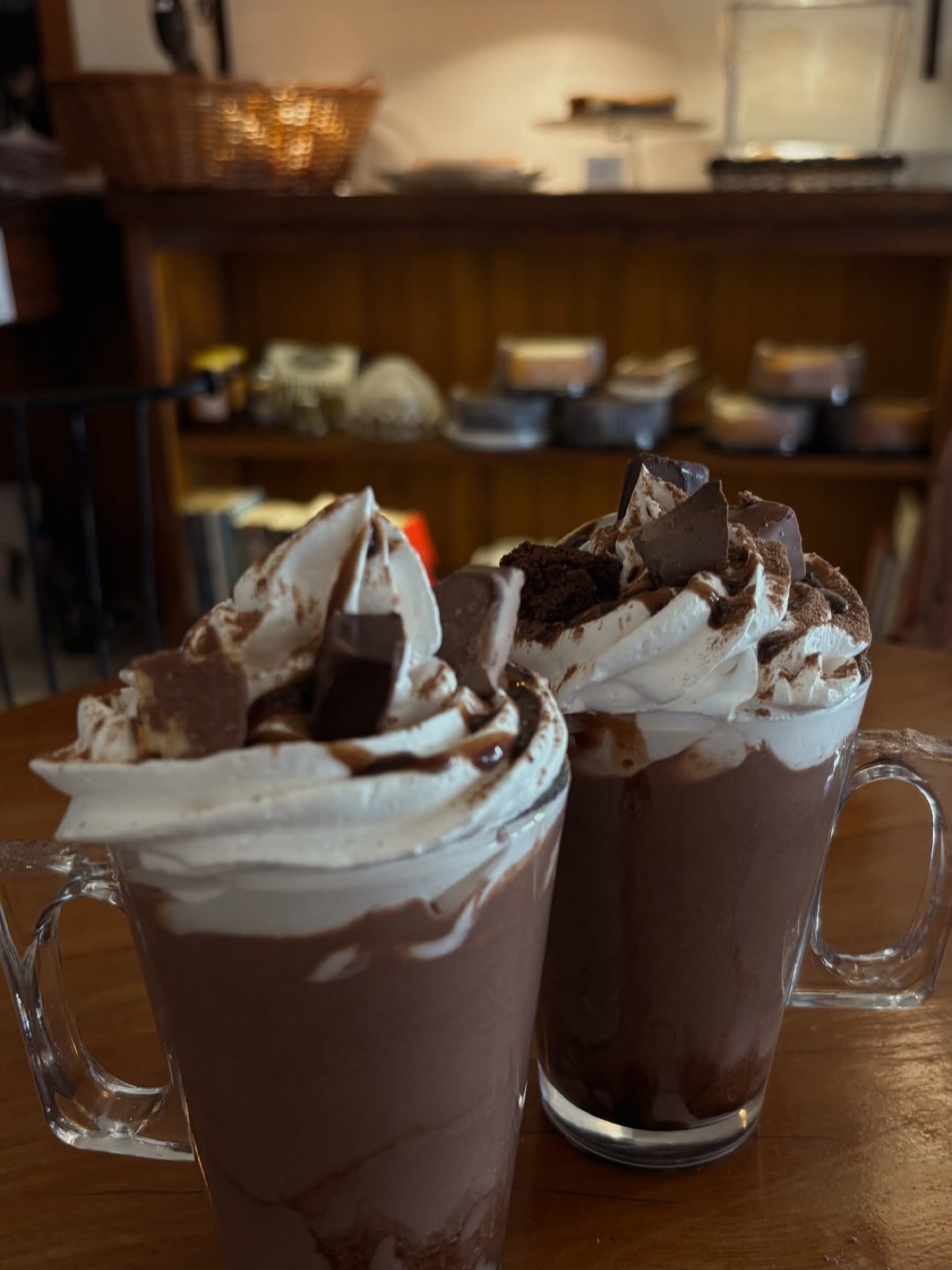 Dois chocolates quentes cremosos com chantilly e pedaços de chocolate